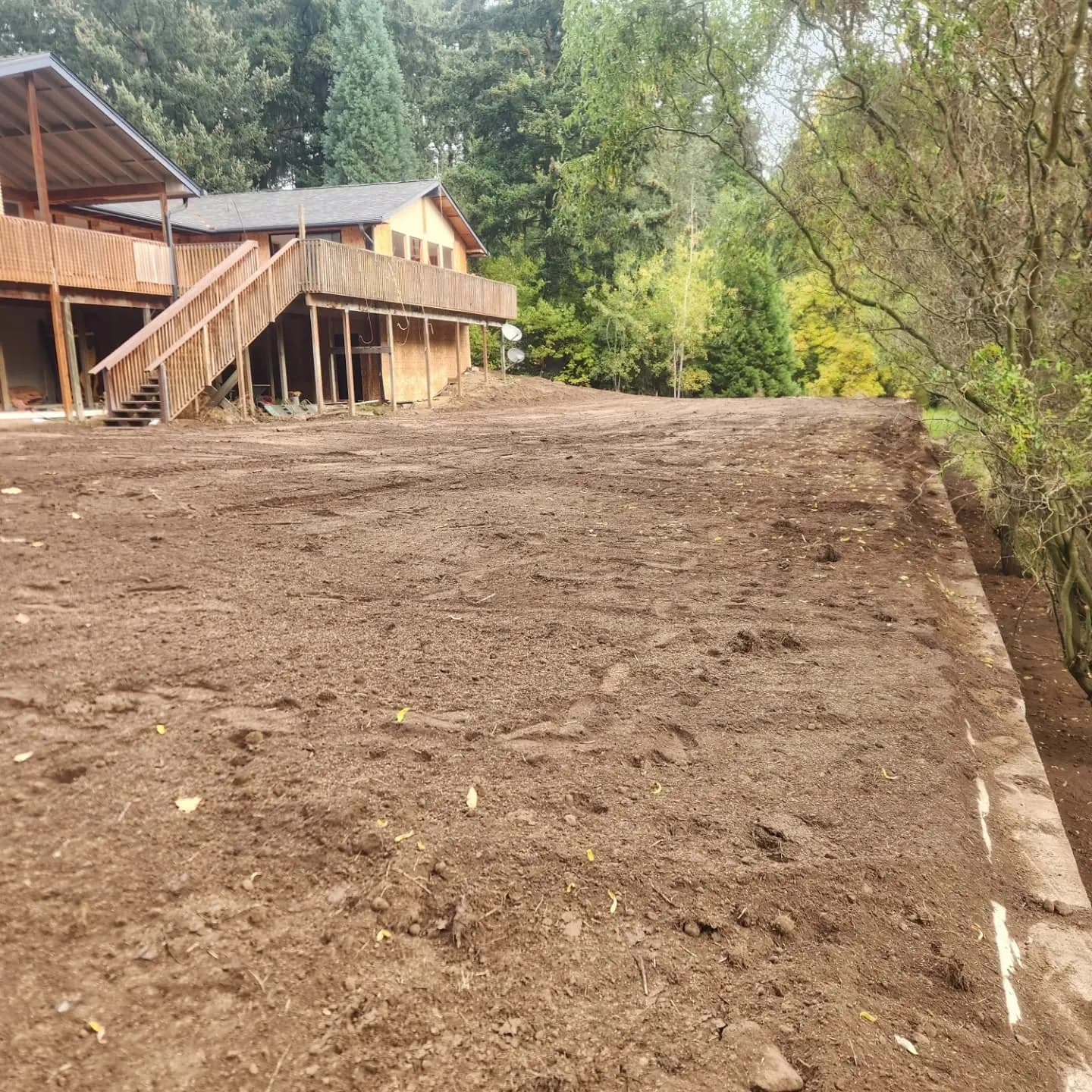 Graded yard below a hillside home after fill was placed